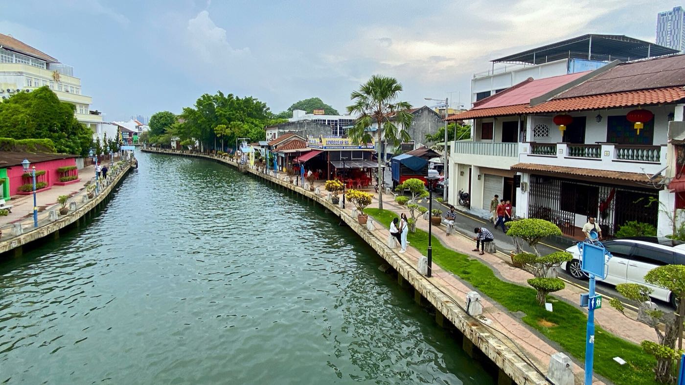 Melaka River lined with heritage shophouses and a landscaped riverside walkway