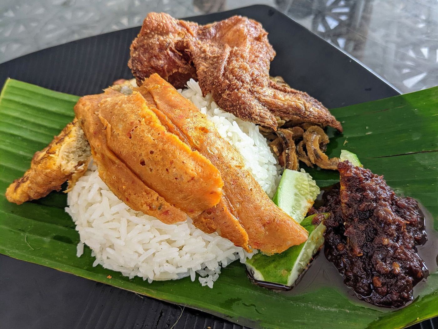 Nasi lemak served on a banana leaf